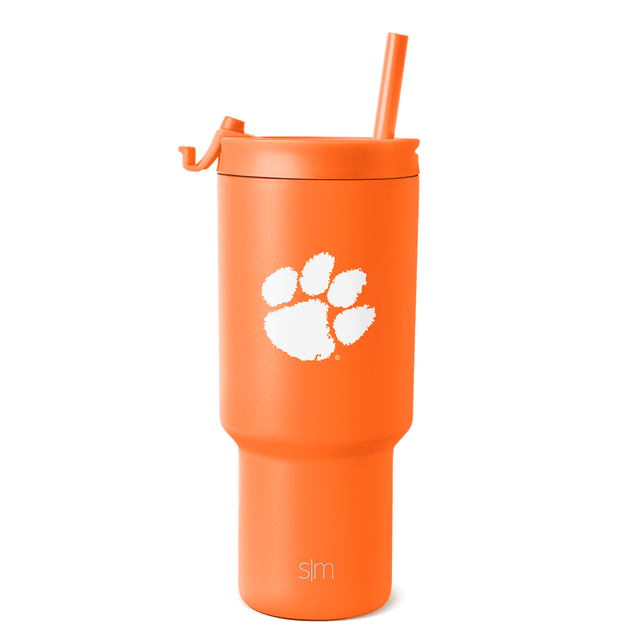 Bright orange tumbler with white paw print graphic and brand text