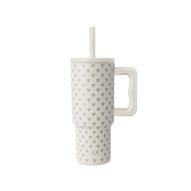 Cream-colored insulated tumbler with gray Mickey Mouse head silhouettes pattern, matching cream lid, handle, and straw