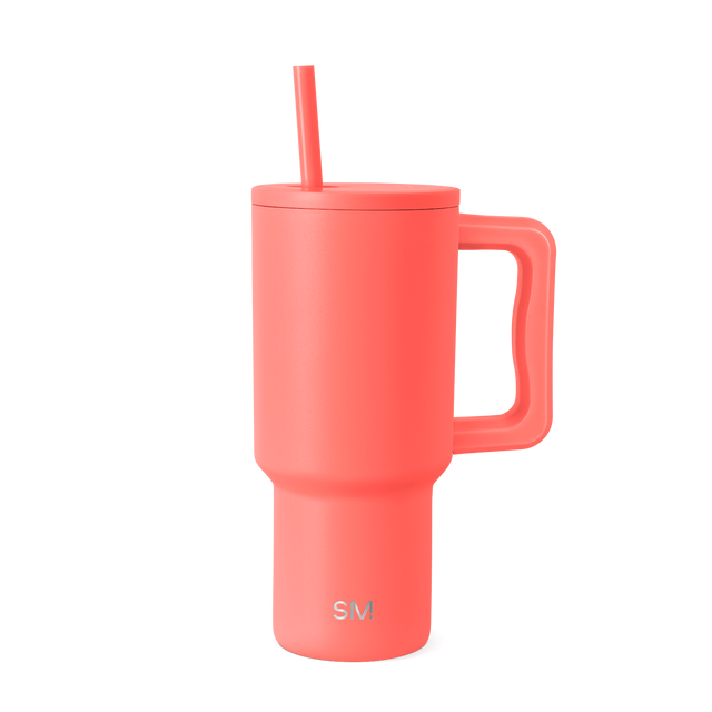 Coral pink tumbler with handles on white background