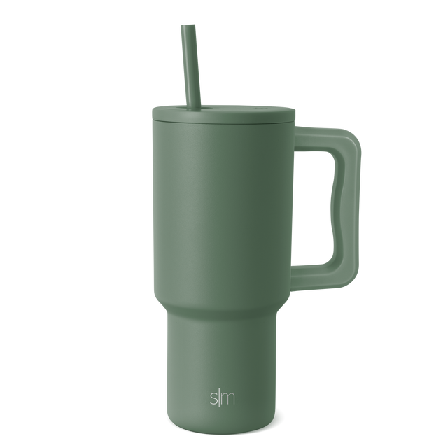 Muted sage green tumbler on a light gray background, viewed at a slight angle to show the cylindrical shape and clean design