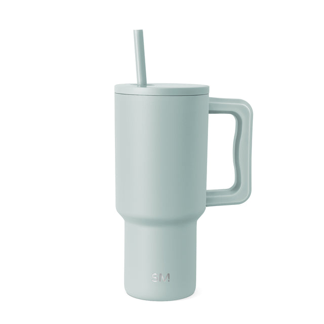 Sage green insulated travel tumbler with handle and matching lid featuring integrated straw, displayed against white background. Simple Modern branded product.