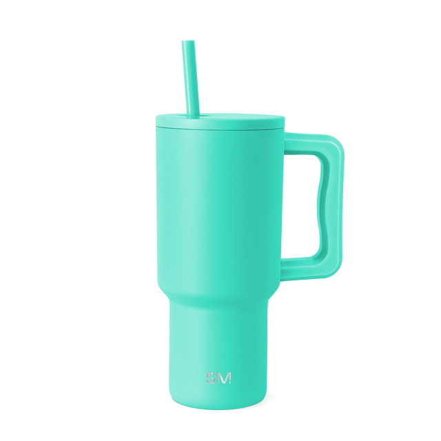Turquoise stainless steel tumbler with matching handle, lid, and straw on white background