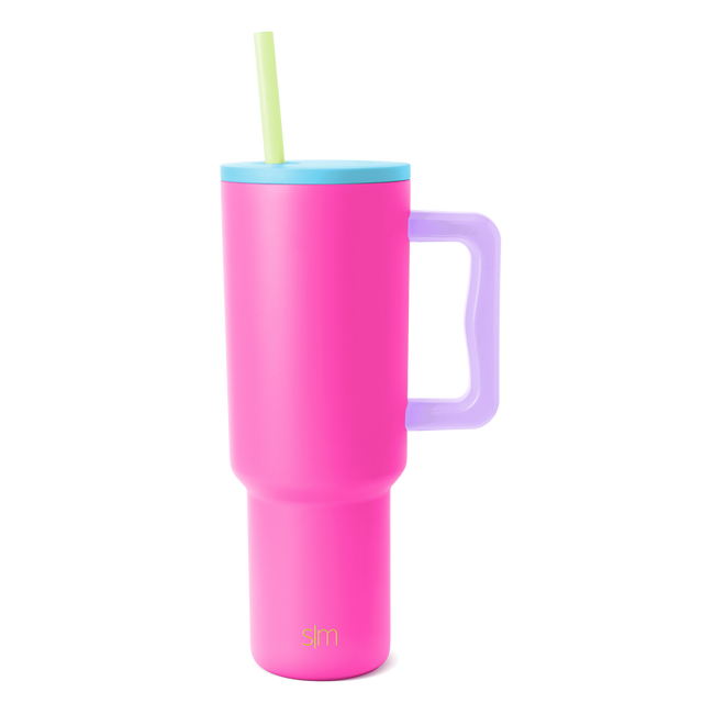 Trek Tumbler insulated beverage cup with hot pink body, sky blue lid, lavender purple handle, and pale yellow-green straw on white background
