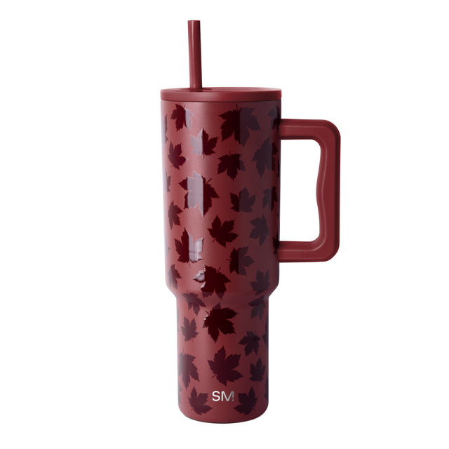 Dusty burgundy mug with scattered deep maroon and wine-colored leaf pattern throughout