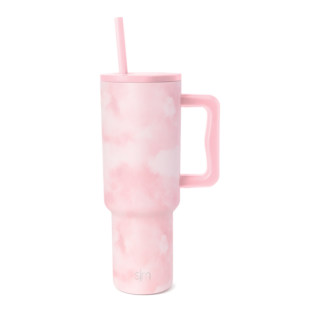 Soft pale pink tumbler with tie-dye watercolor cloud pattern in blush and rosy pink tones throughout the vessel