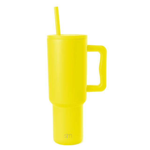 Bright yellow insulated tumbler with lid on white background
