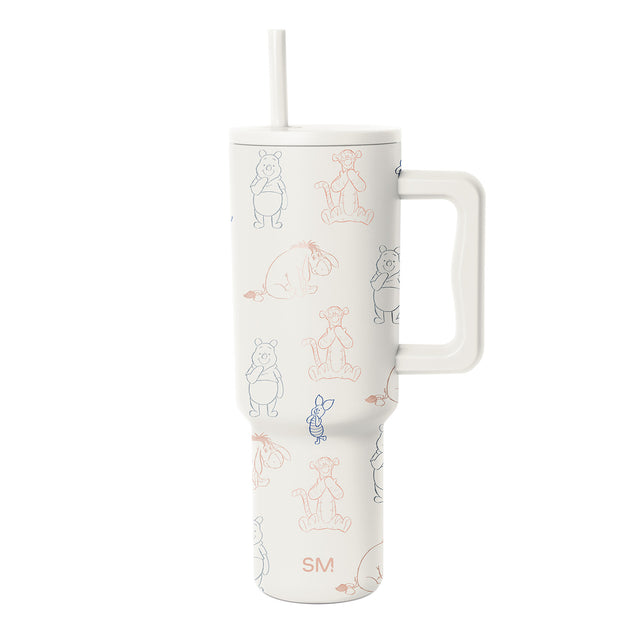White insulated tumbler with handle featuring line-art storybook characters including Winnie the Pooh in gray and Tigger in coral pink on all-over pattern design.
