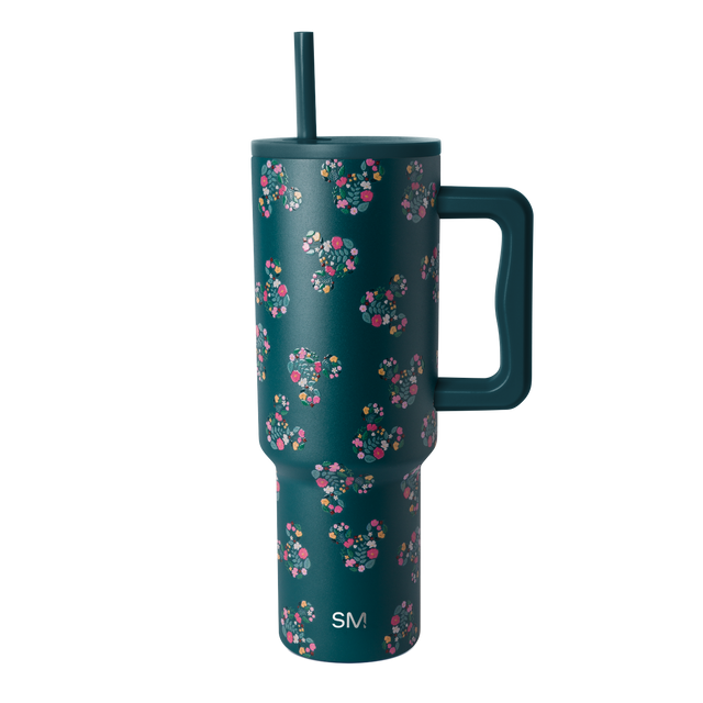 Deep teal drinkware with vibrant floral pattern in hot pink, coral, magenta, white, cream, and yellow accents.