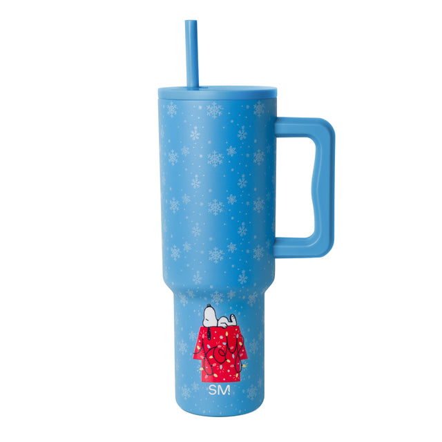 Bright periwinkle blue tumbler with white snowflakes and dots scattered across the surface, featuring a winter-themed design.