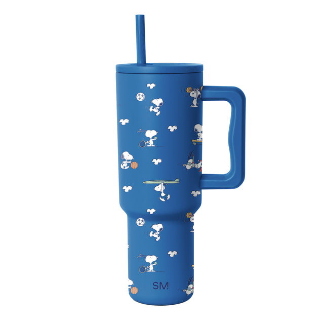 Royal blue tumbler with white and cream graphic elements and tan and brown accents