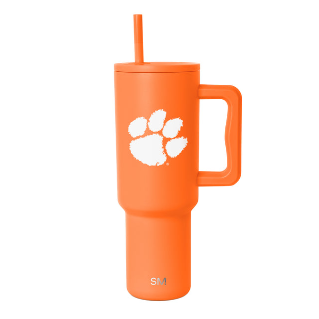 Vibrant bright orange tumbler with paw print design on white background