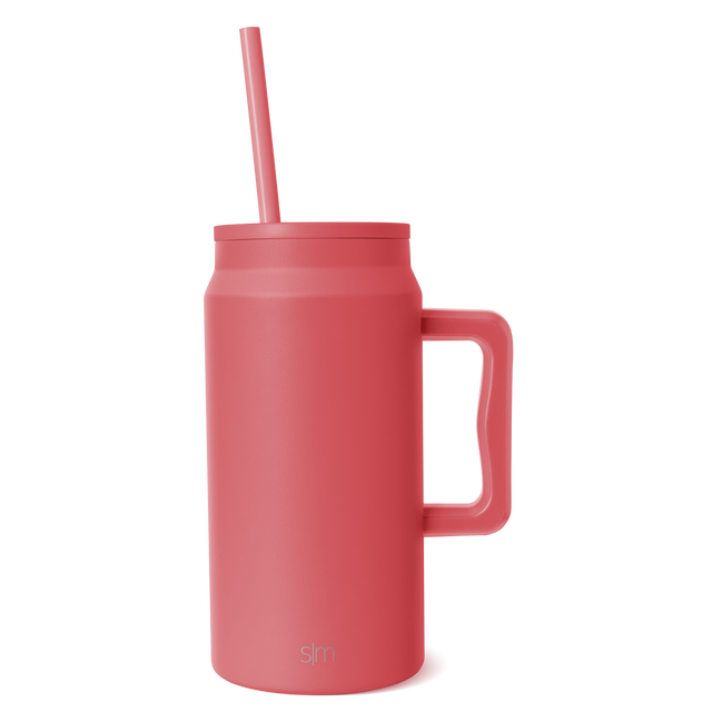 Coral-red ceramic mug with white interior on white background, product photography for drinkware.