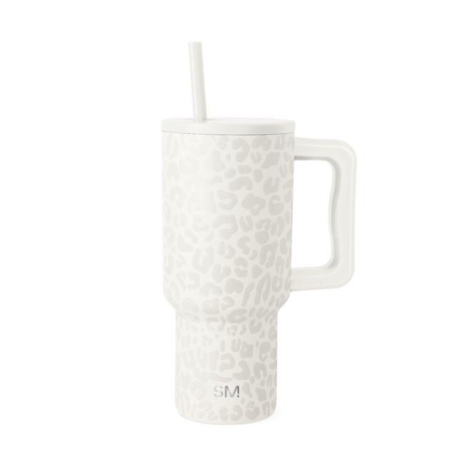 Cream-colored tumbler with subtle leopard print pattern in white and cream tones