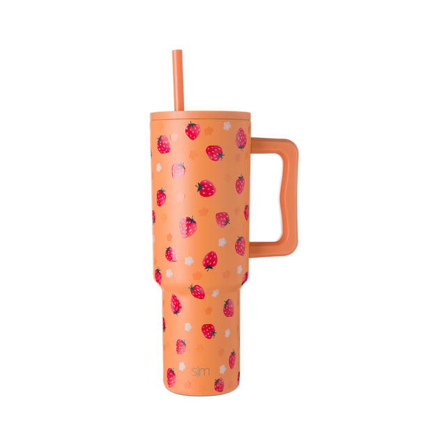 Peachy-coral tumbler with vibrant magenta and hot pink strawberry illustrations and pale gray-white dots scattered across the surface.