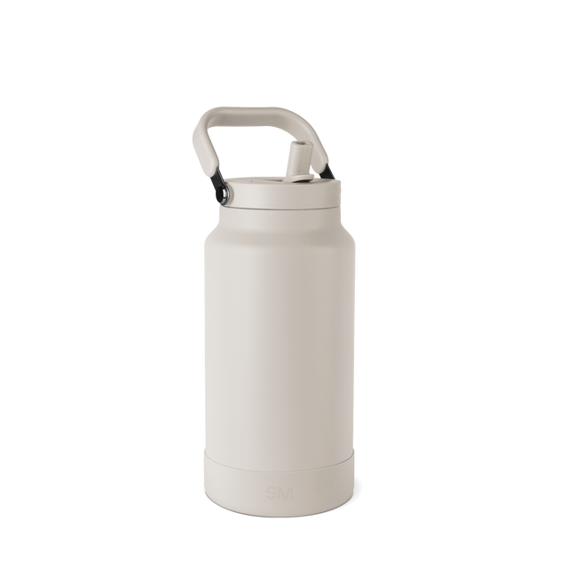 Cream-colored water bottle with aluminum accents on a pale gray-white background