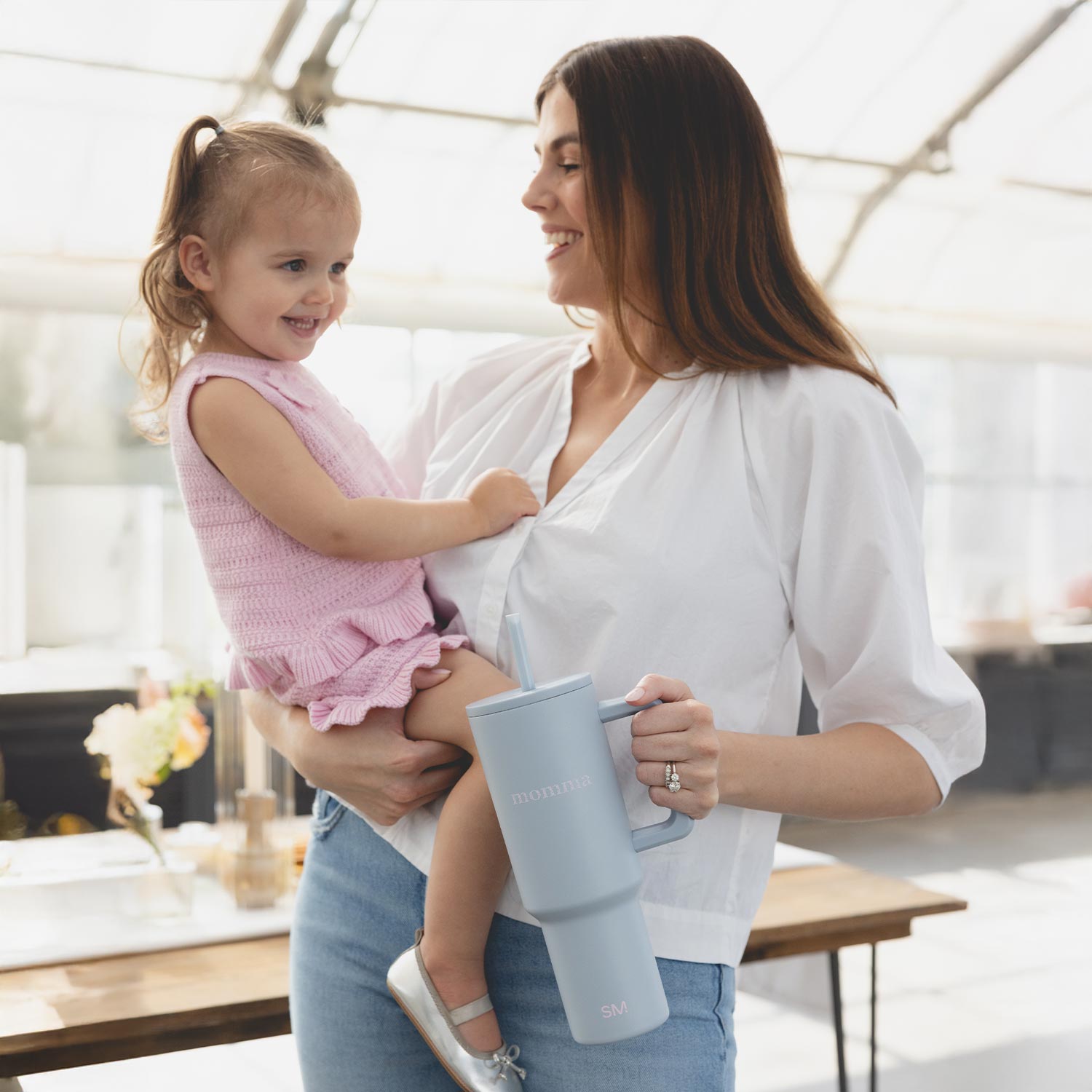 Close-up of a single green leaf against a white background.