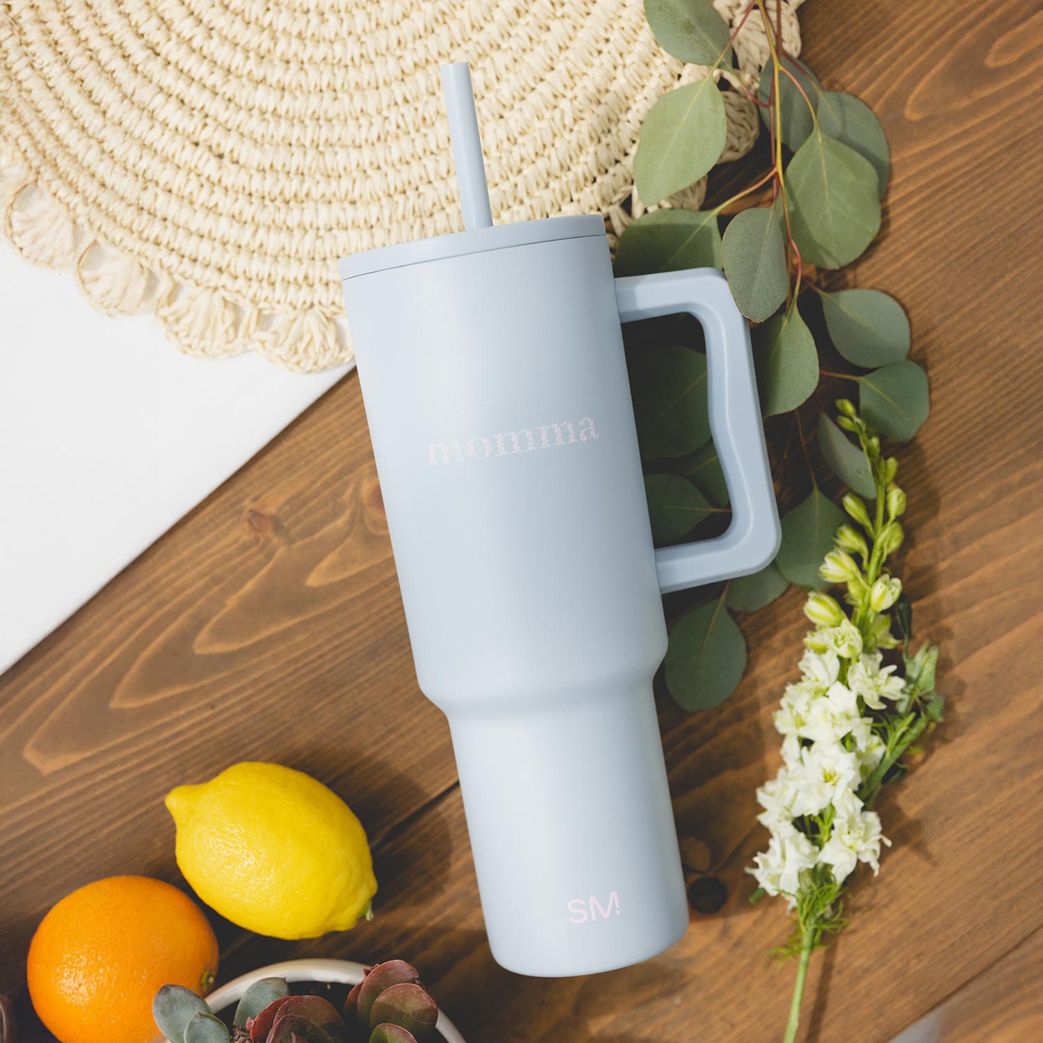 Close-up of a single green leaf against a white background.