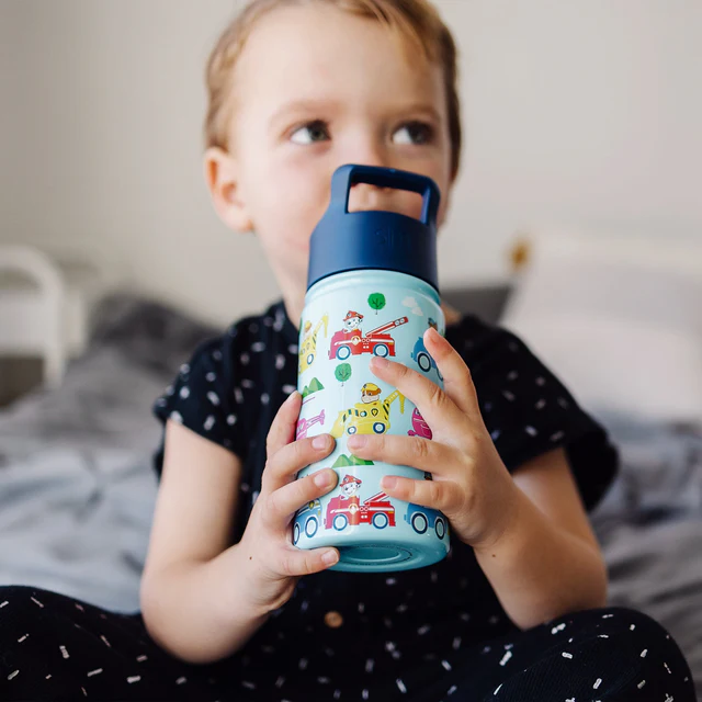 Baby holding Nickelodeon bottle
