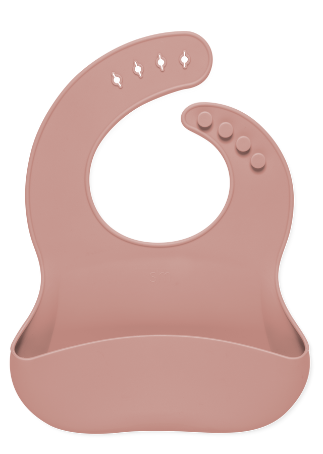 Dusty rose mauve baby bib displayed against a white background