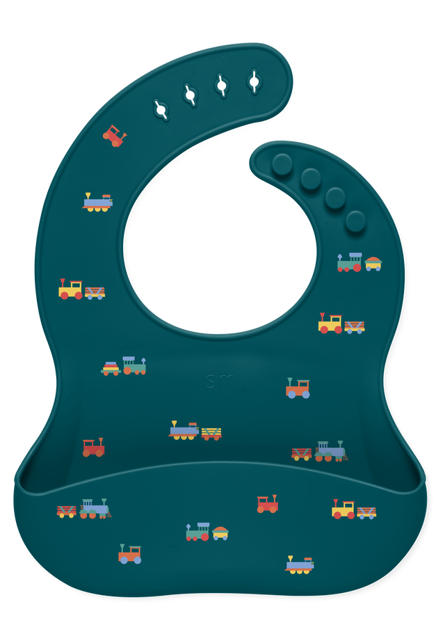Teal-green bib with railroad and train illustrations featuring bright accent colors and dimensional detailing