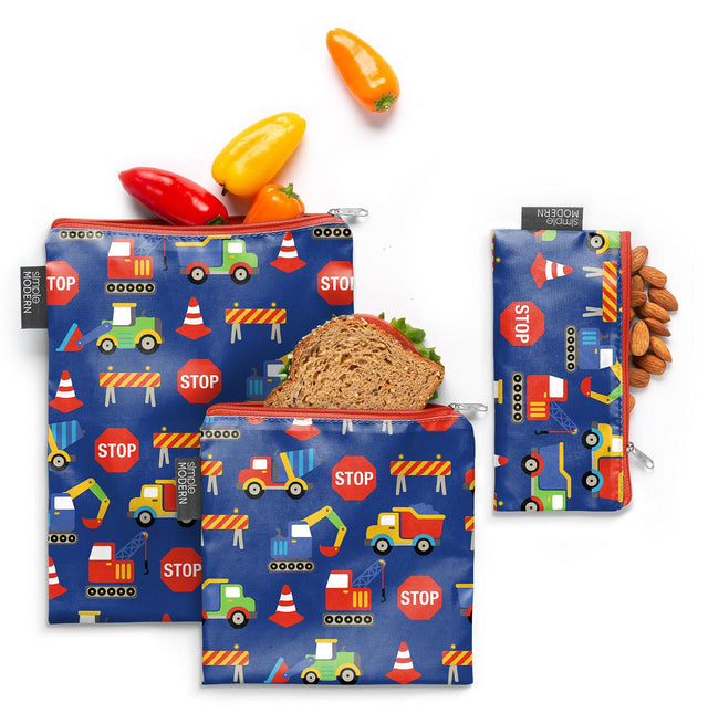 Navy blue reusable snack bags with construction theme design featuring bright red and primary colored accents on fabric pouches.
